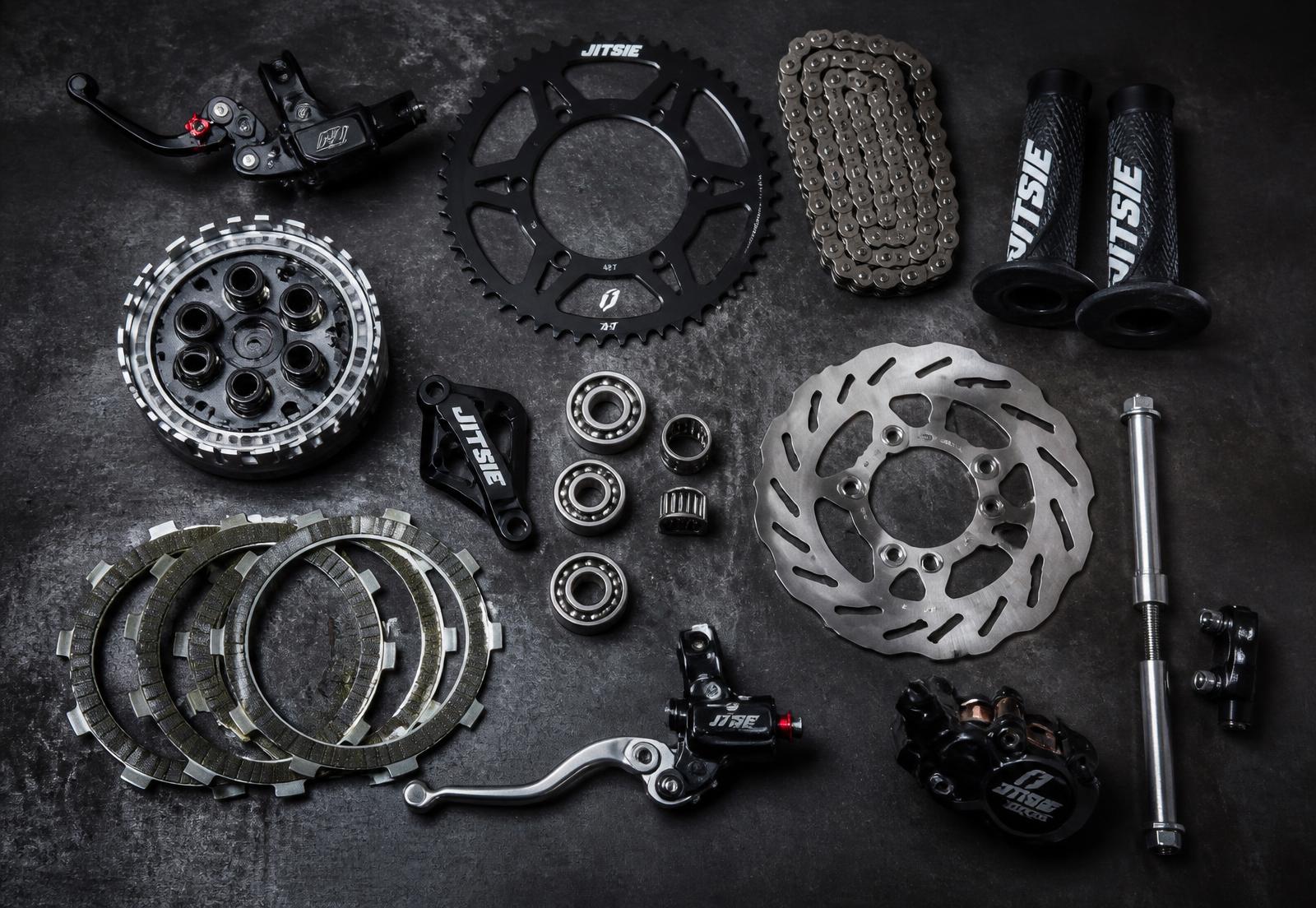 Trials motorcycle spare parts on a workshop bench